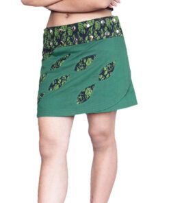 Model wearing a handmade green boho cotton skirt featuring a black printed waistband with metal studs and matching leaf-shaped appliqué patterns. The skirt has an asymmetrical wrap design and a casual, artistic look.